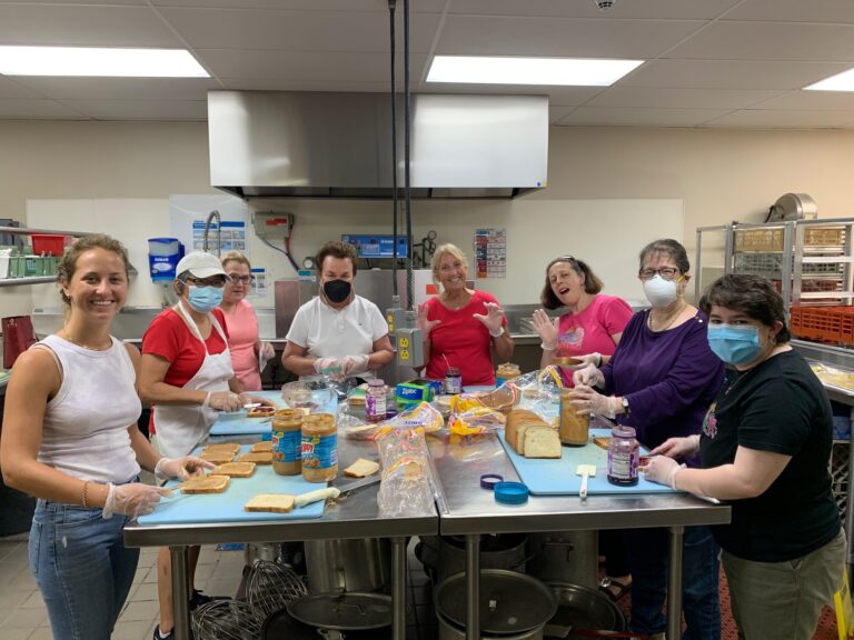 Volunteers making peanut butter sandwiches in the kitchen